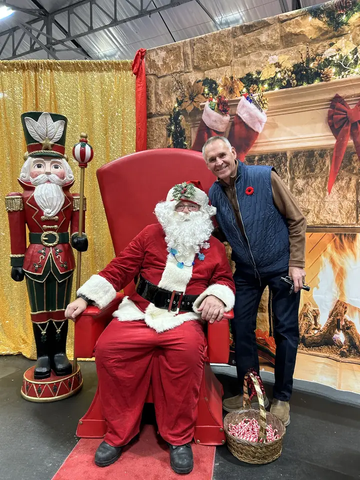 Gaétan with Santa Claus at a community event